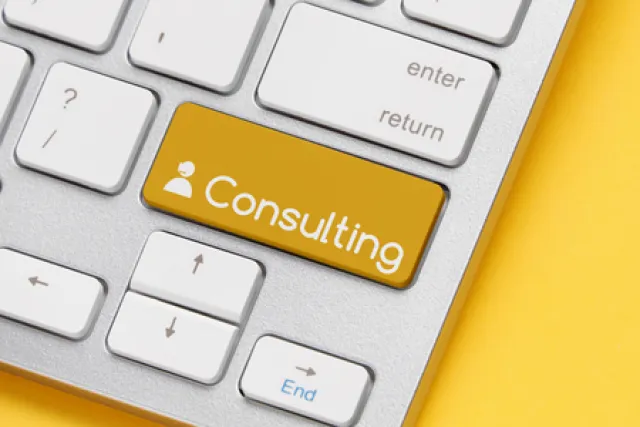 A computer keyboard with 'Consulting' written on the Shift key