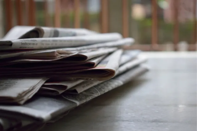 A stack of newspapers on a table